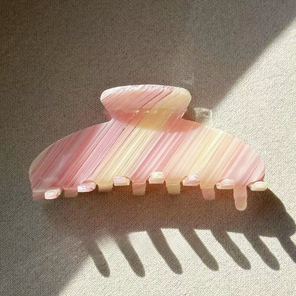 Angled view of Gentle Curve Hair Claw in cream pink stripe pattern, ideal for quick updos and ponytails.