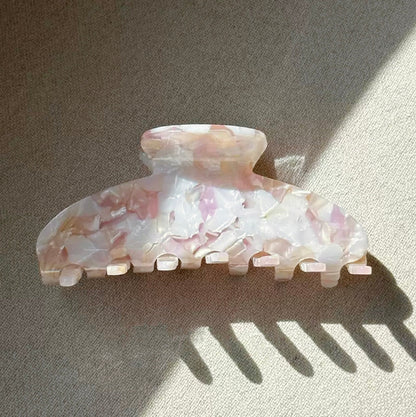 Folded view of Gentle Curve hair claw in rose shell , ideal for quick updos and ponytails.