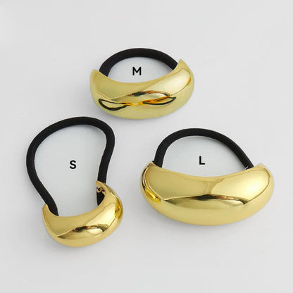 Angled view of  gold Gleaming Curve Hair Cuff in different sizes , ideal for quick updos and ponytails.