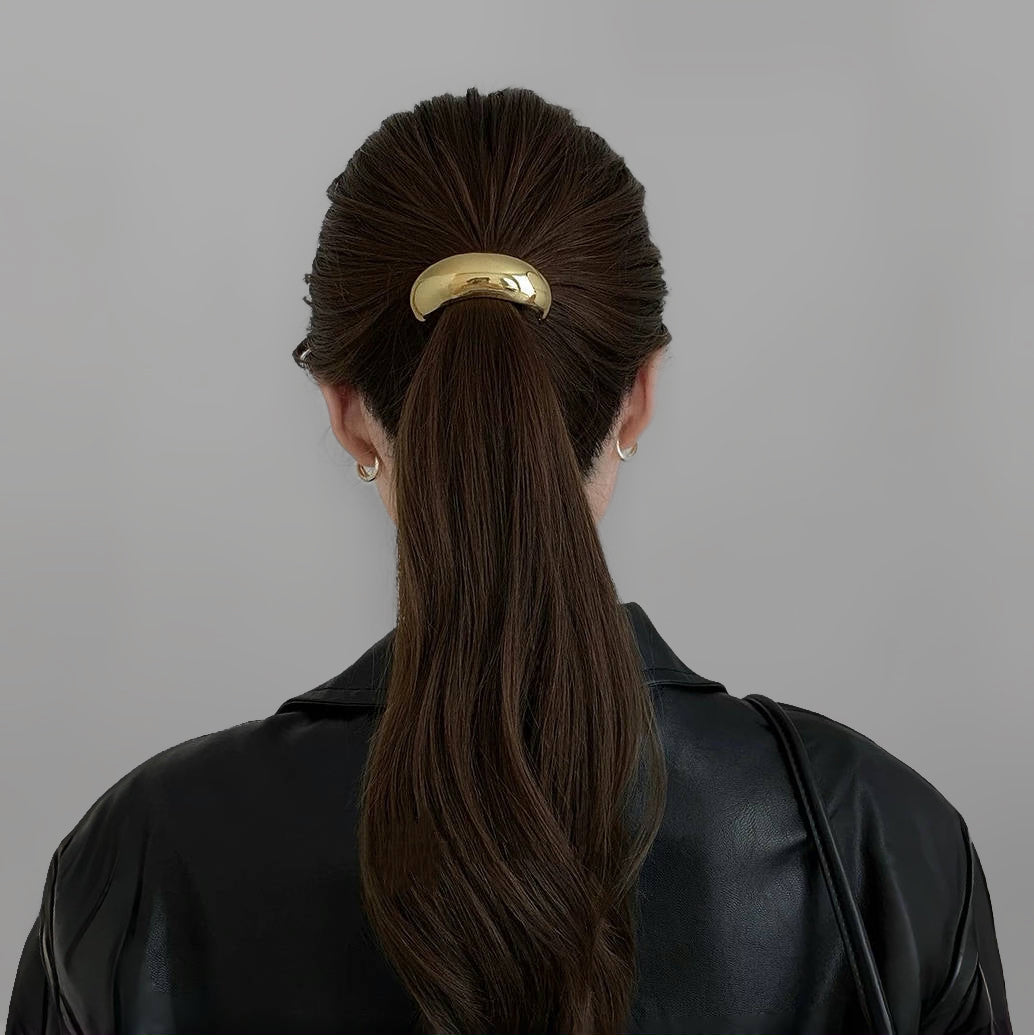 Model wearing a large Gleaming Curve Hair Cuff in gold, easy for workdays and special occasions.