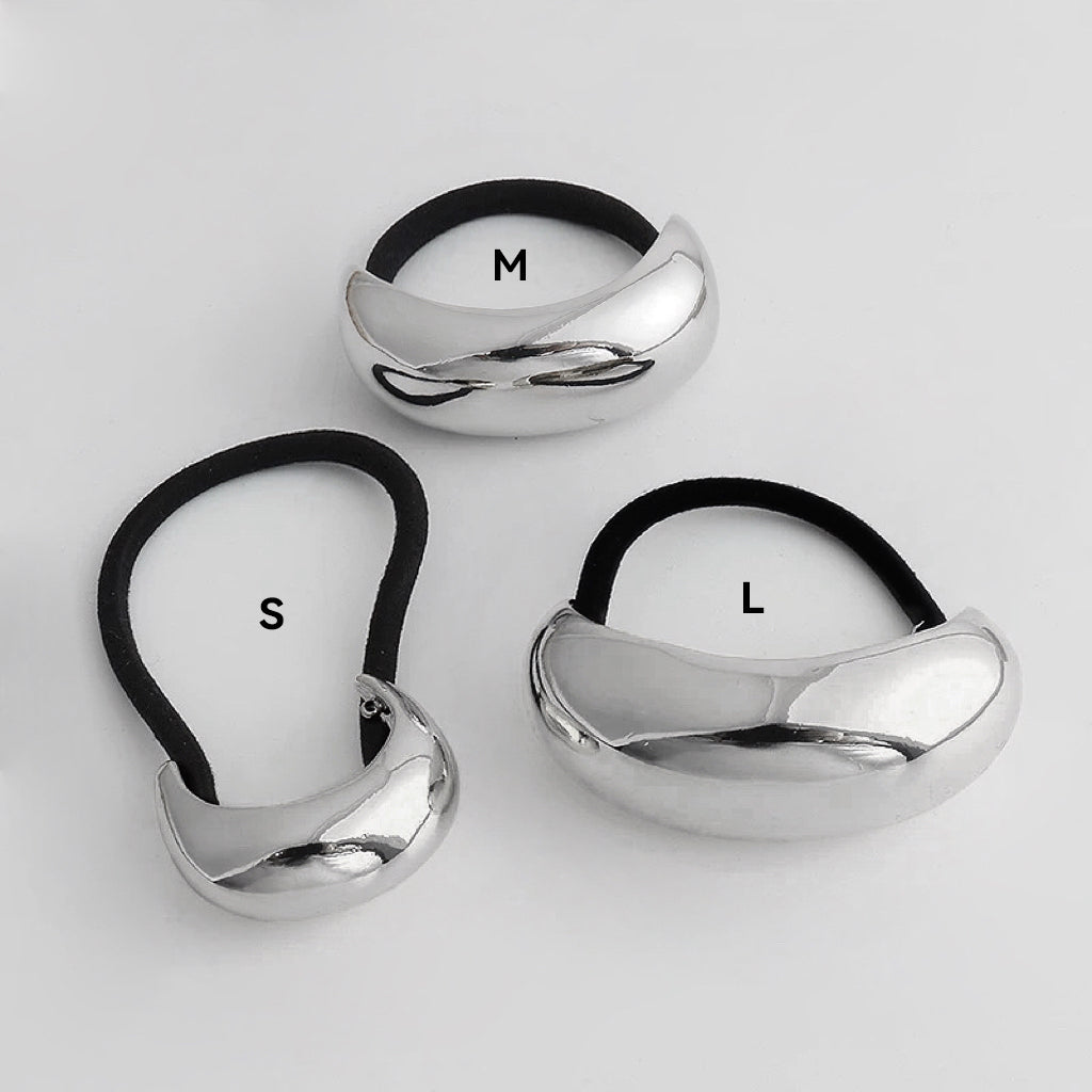 Front view of three silver Gleaming Curve Hair Cuff hair accessory in different sizes.