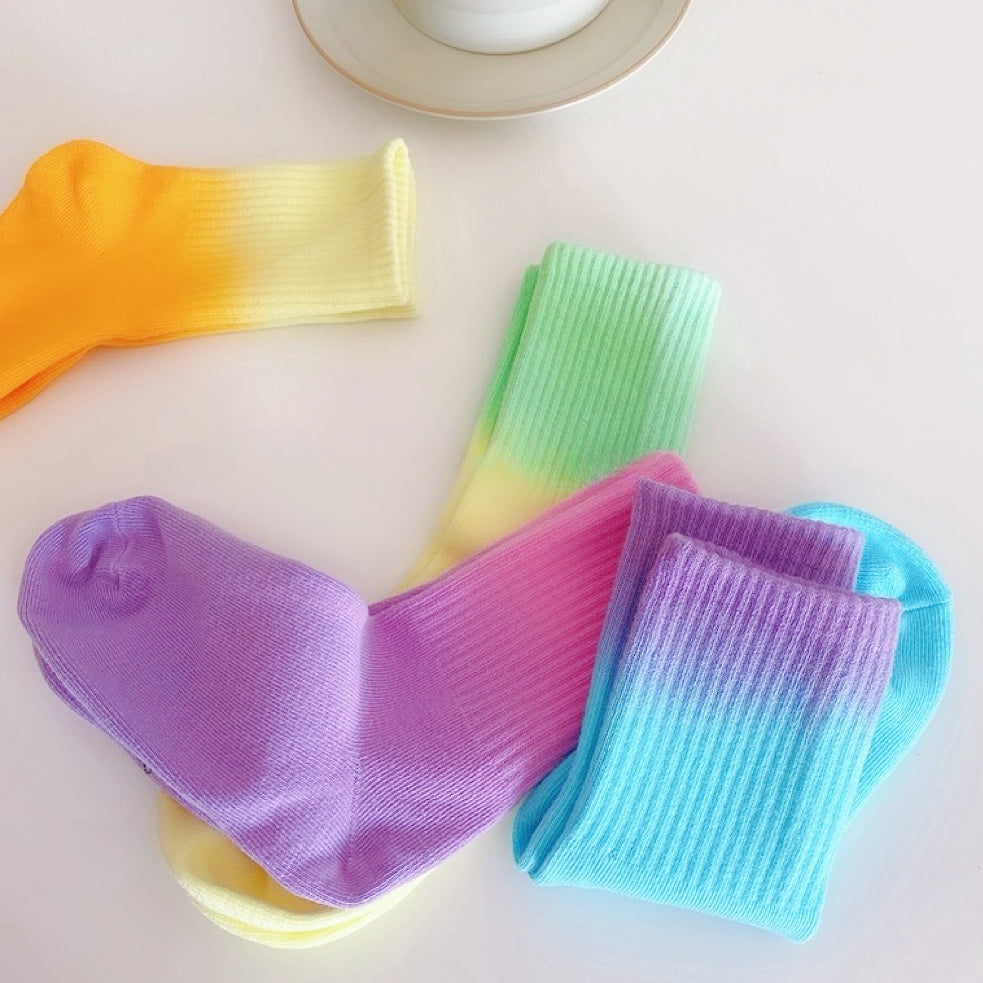 Angled view of 4 colors of Gradient Rainbow Socks, great for daily wear and lounging.