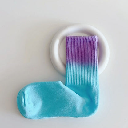 Flat lay of Gradient Rainbow Socks in blue and purple, great for daily wear and lounging.