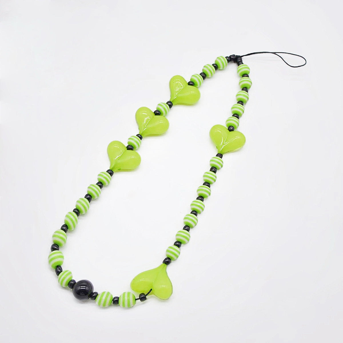 Angled view of Heart Beat Phone Charm with lime green hearts and striped bead.