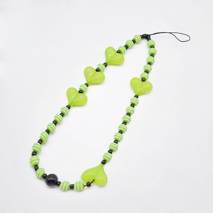 Angled view of Heart Beat Phone Charm with lime green hearts and striped bead.