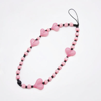 Close-up of Heart Beat Phone Charm with pink hearts and striped bead.