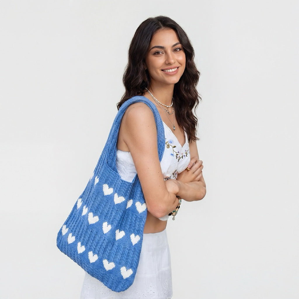 Model carrying a blue Heart Pattern Crochet Tote Bag on shoulder, great for daily carry and travel.