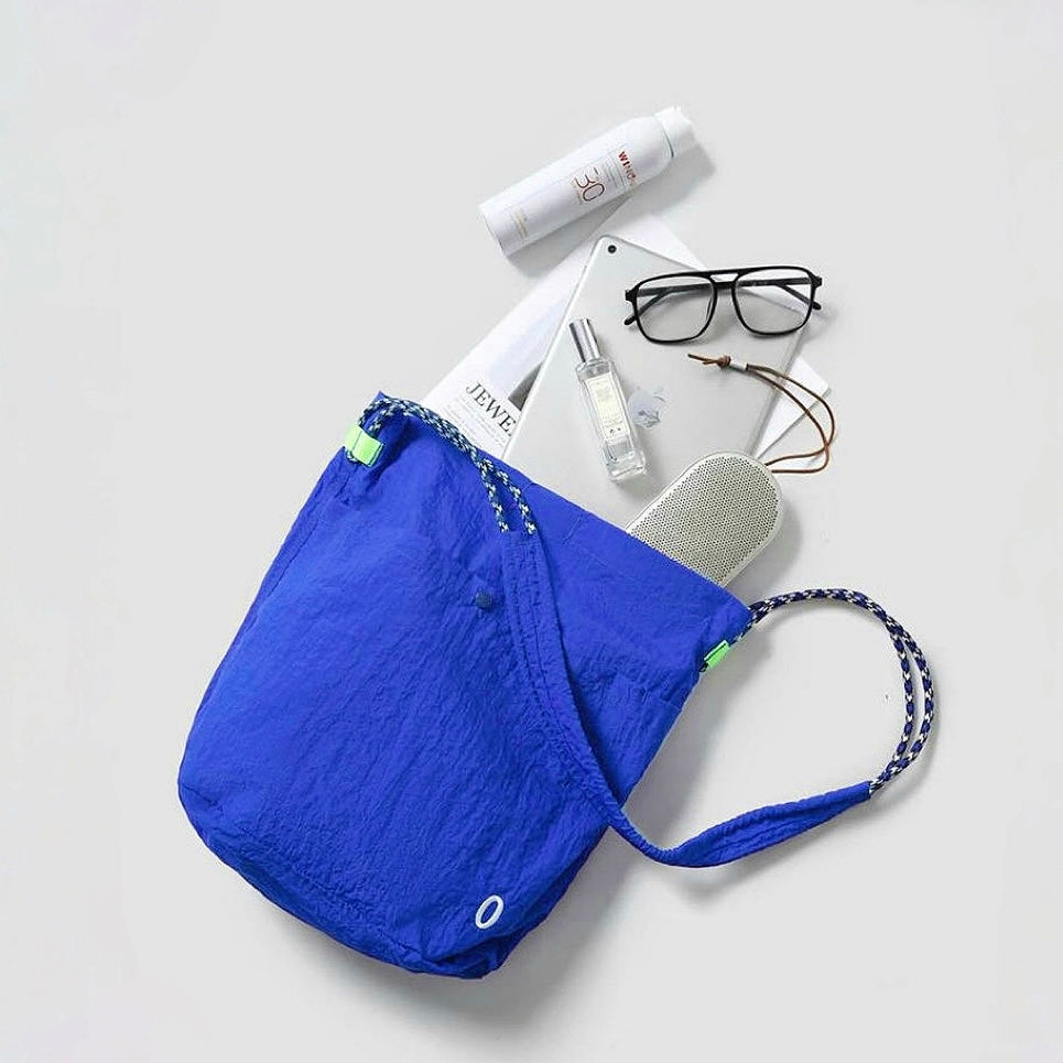 The interior of a Breezy Trail Bag with daily essentials like glasses and a notebook, highlighting its spacious size.
