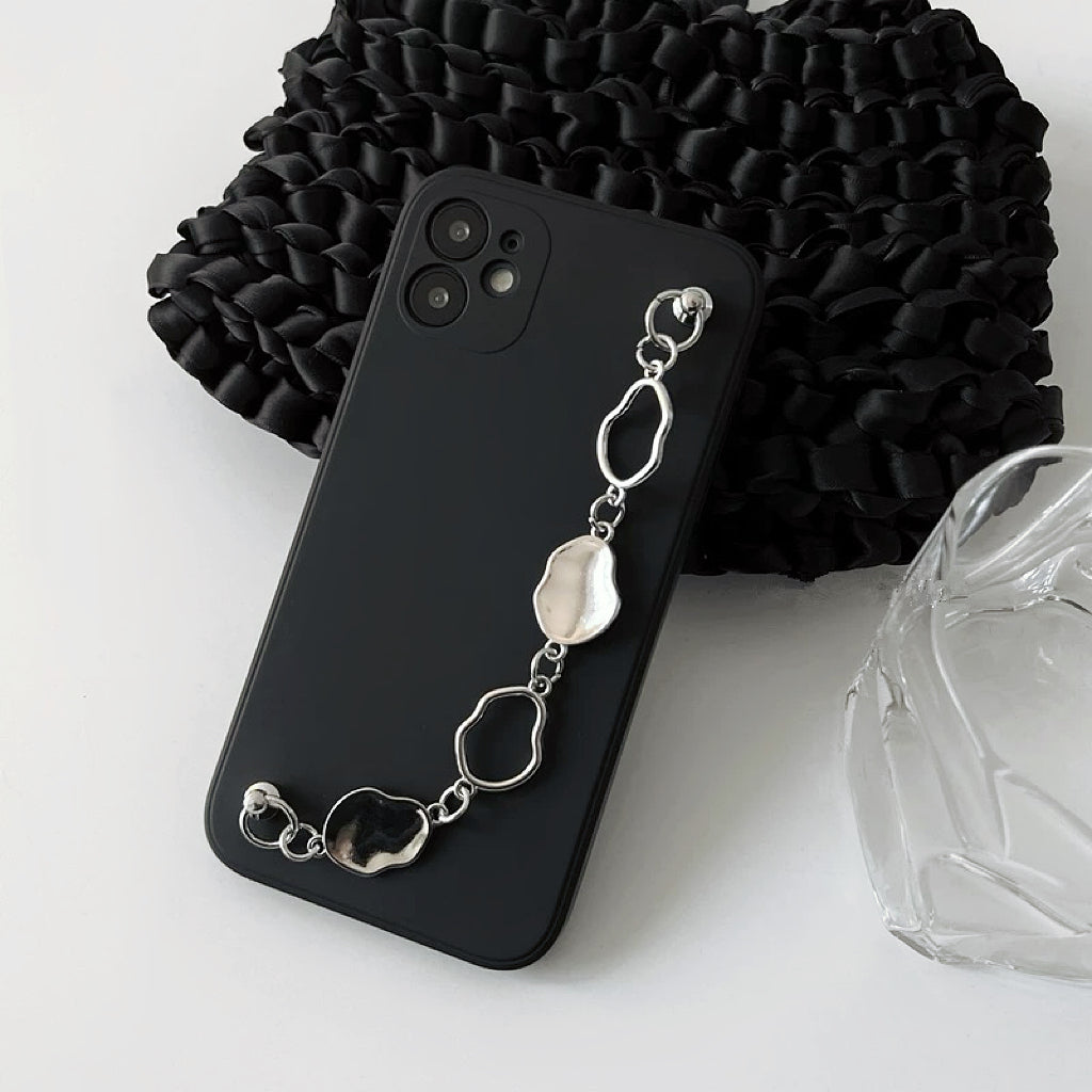 Black silicone case with a silver irregular metal chain wrist strap. Stylish urban techwear accessory.