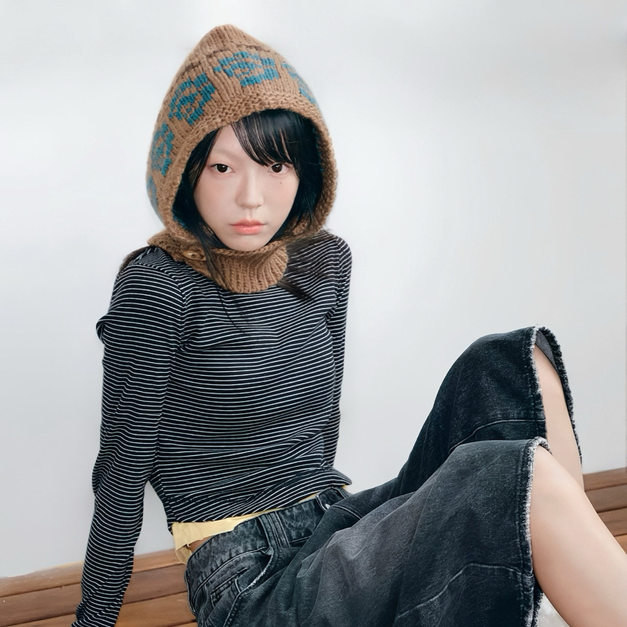 Model wearing Jacquard Knitted Balaclava in khaki, showcasing a cozy natural wool blend with artistic jacquard motifs.