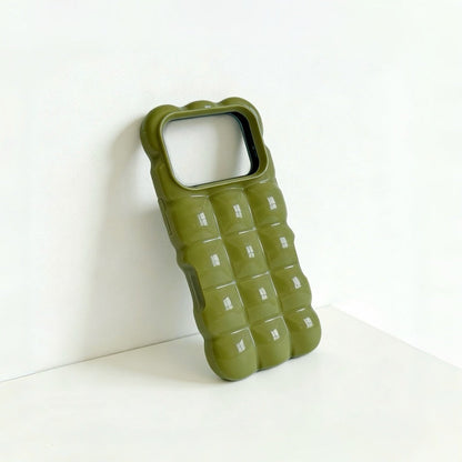 Close-up of a green jelly case with a glossy 3D bubble texture.