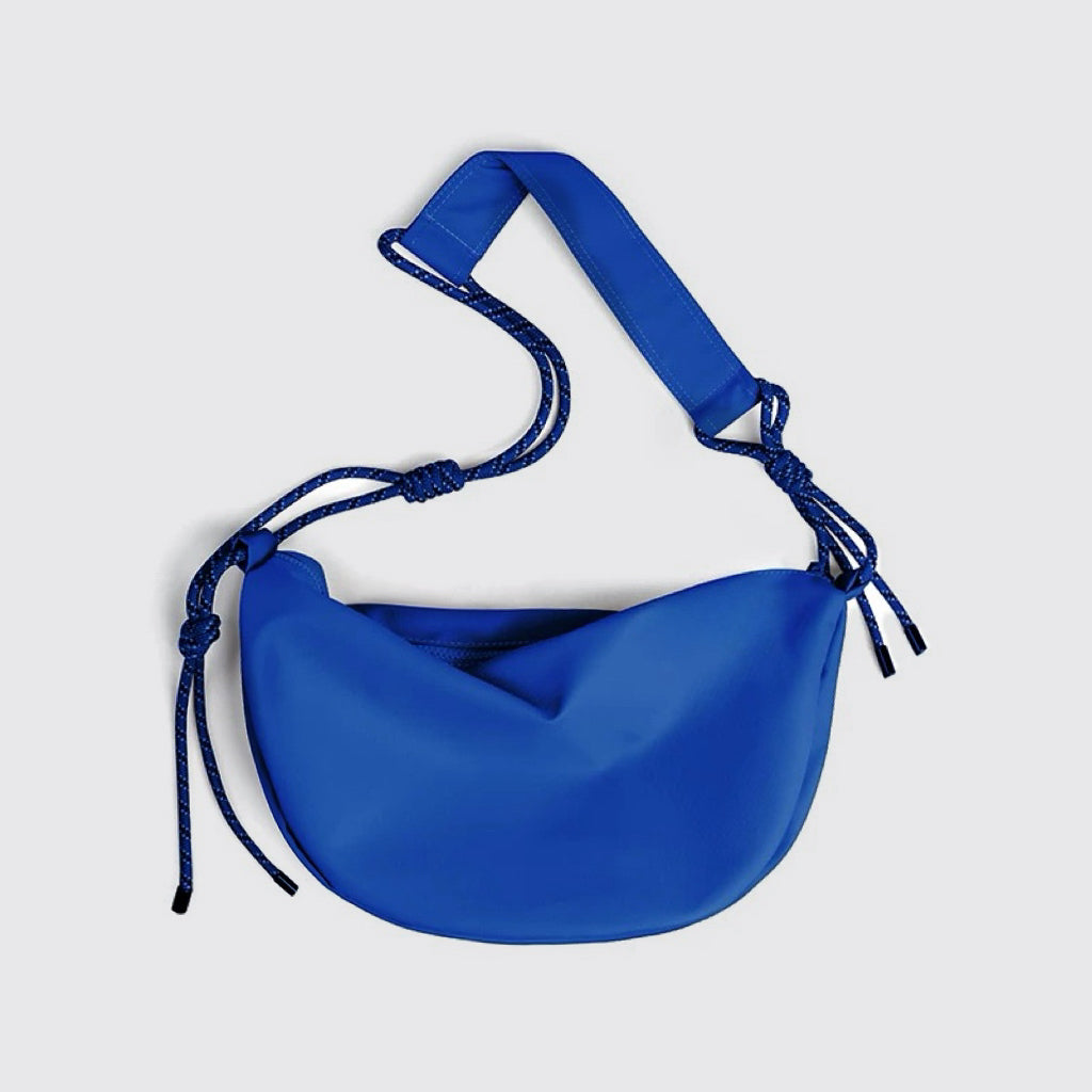 Front view of cobalt blue nylon crescent sling bag, best affordable knotted hobo bag for daily style.