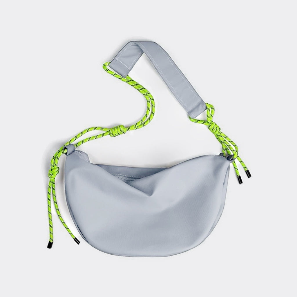 Front view of light grey nylon crescent bag with neon knotted strap detail,  unique streetwear hobo bag.