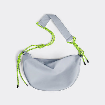 Front view of light grey nylon crescent bag with neon knotted strap detail,  unique streetwear hobo bag.