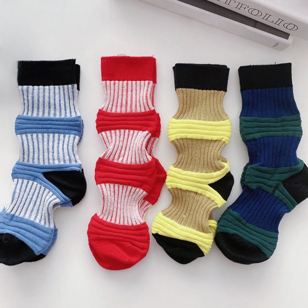 Close-up of 4 pairs of Lantern Colored Socks in red, dark green, light blue and yellow.