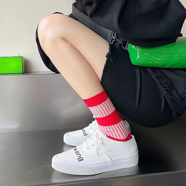 Model wearing a pair of red lantern socks, great for casual wear and light workouts.