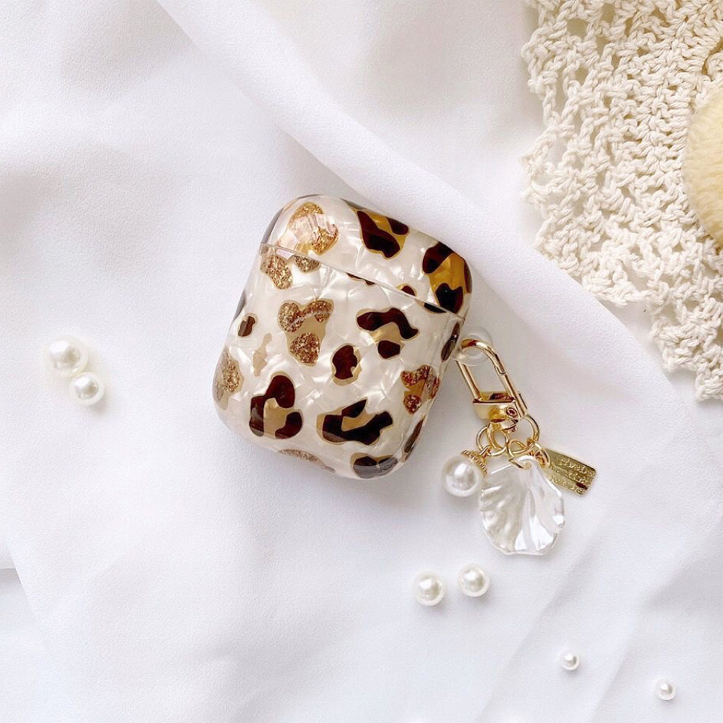 Angled view of Leopard Print AirPods Case Cover with shell charm, great for daily protection and travel.
