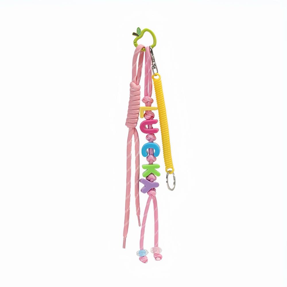 Front view of Pink polyester bag charm with colorful LUCKY letters, pink ropes and a green spring.