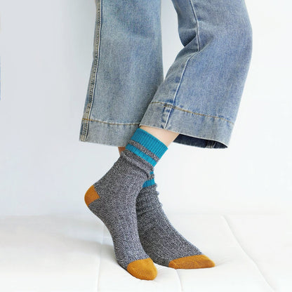 Model wearing a pair of dark gray cotton socks, easy for travel days and daily comfort.