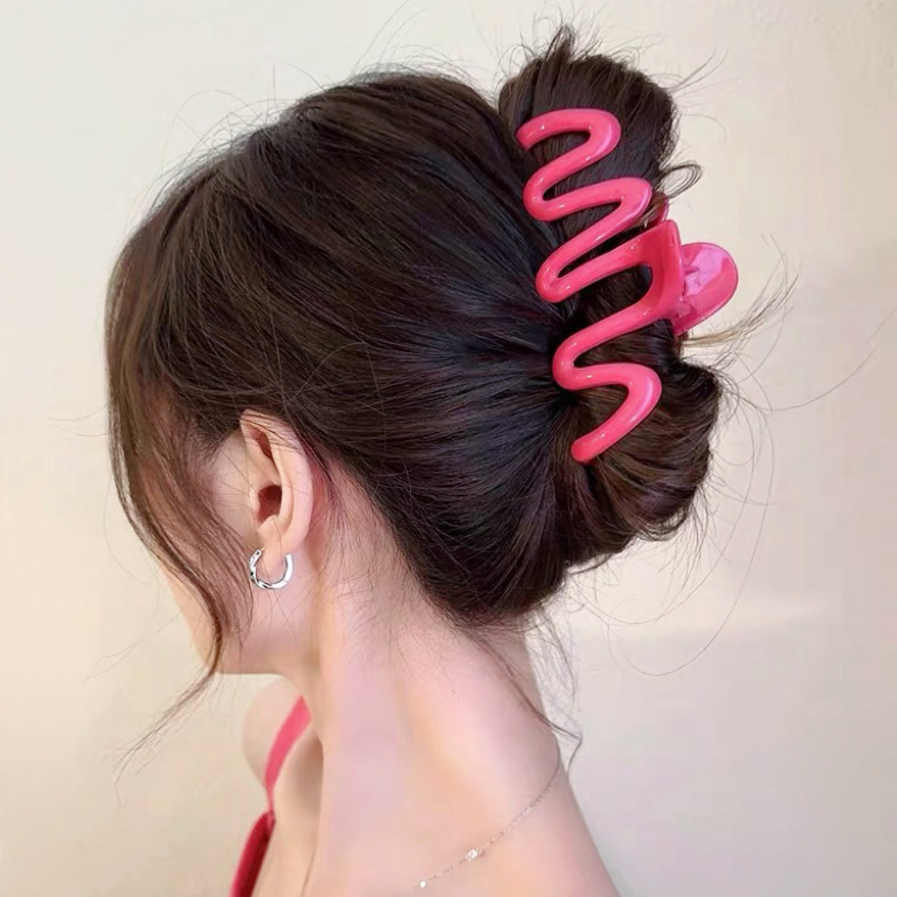 Model wearing Macaron Wave Hair Claw in pink, ideal for quick updos.