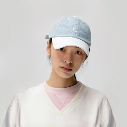 Model wearing light blue Mash Up Stripe C Cap, showcasing eclectic striped patterns on lightweight cotton material.
