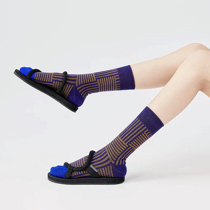 Model wearing a pair of blue matrix striped socks, ideal for everyday outfits and sneakers.