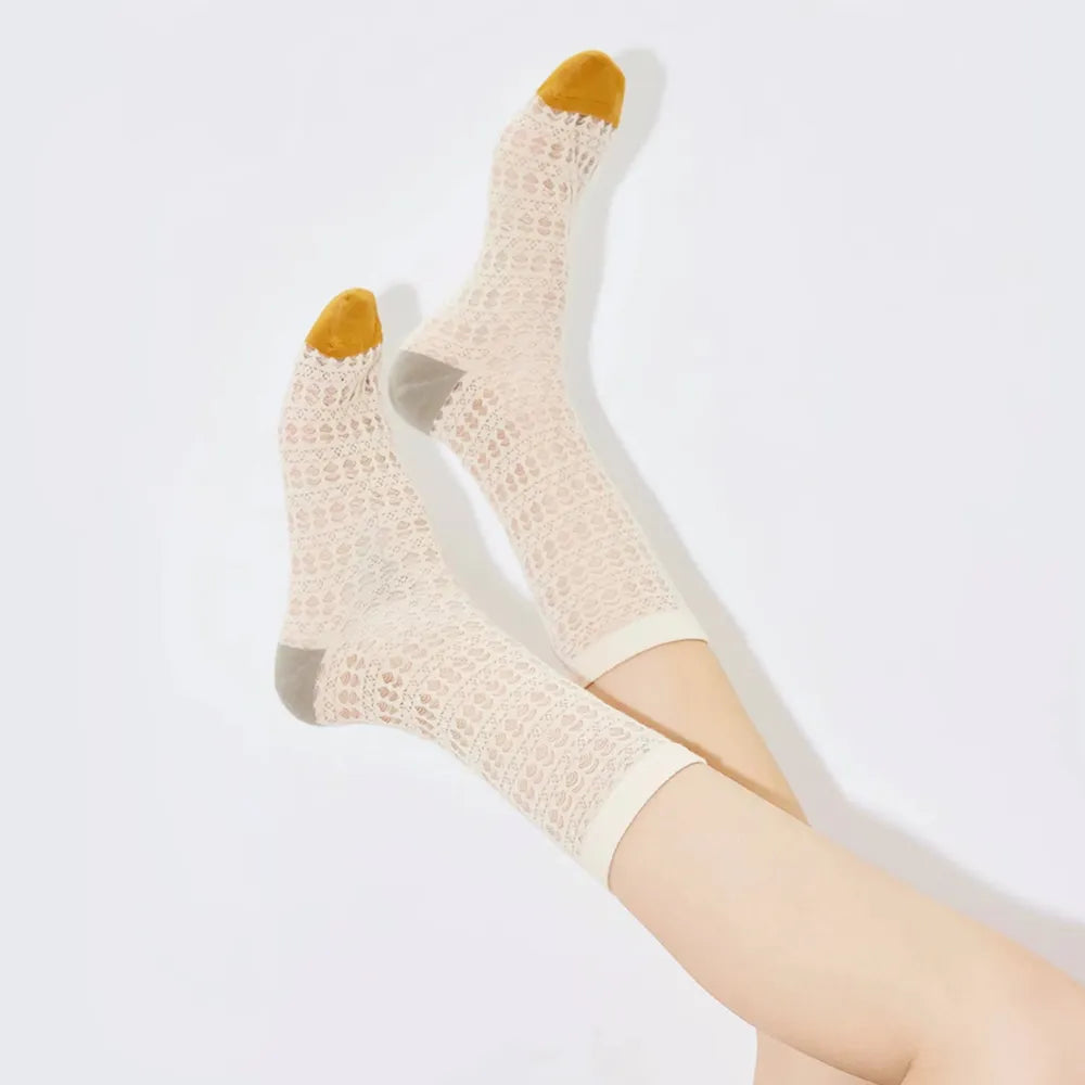 Close-up of Mesh Gauze Colored Socks in white, easy to pack for travel and errands.