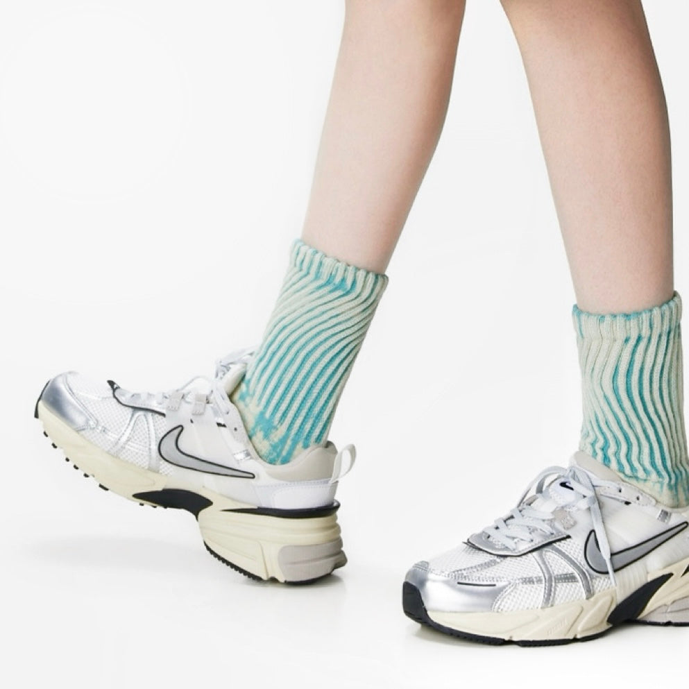 Model wearing a pair of  Metallic Tie Dye Slouch Socks, ideal for workouts and commuting.