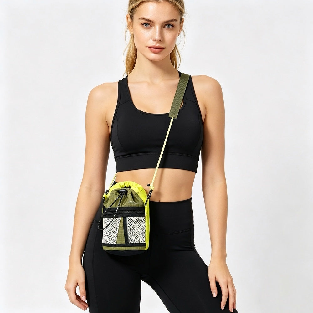 Woman in black activewear with a sporty mini bucket crossbody bag, featuring braided rope strap and mesh
