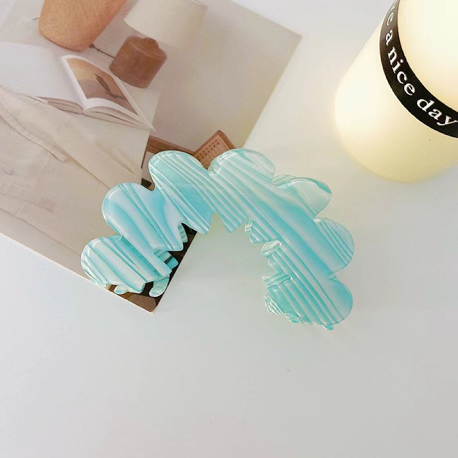 Angled view of Moon Hair Claw  in blue, great for everyday styling and gifting.