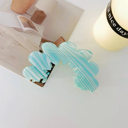 Angled view of Moon Hair Claw  in blue, great for everyday styling and gifting.