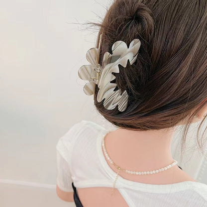 Model wearing Moon Hair Claw hair claw clip in gray, easy for workdays and special occasions.
