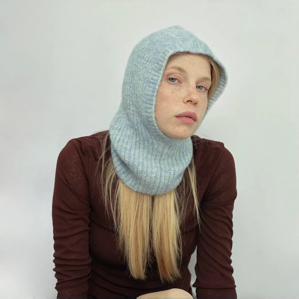 Model wearing blue Morandi Toned Knit Balaclava Hat, showcasing a sophisticated color palette for daily wear.