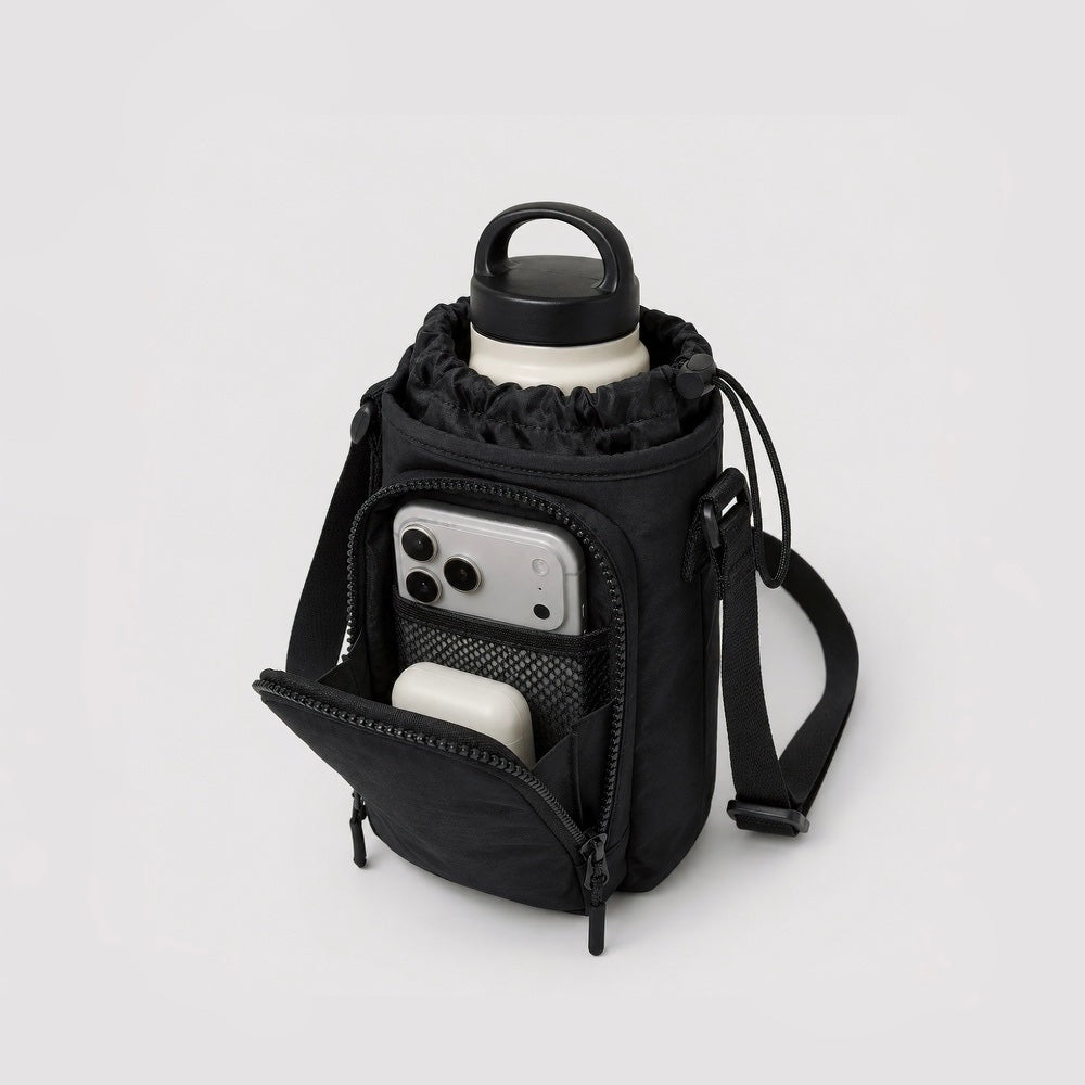 Close-up view of the open front zipper pocket showing an internal smartphone sliding into the separate storage slot.