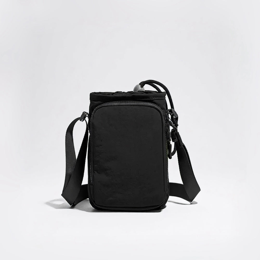 Studio view of the tactical matte black multi-way water bottle sling pouch with adjustable crossbody straps.