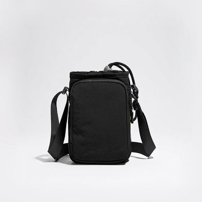 Studio view of the tactical matte black multi-way water bottle sling pouch with adjustable crossbody straps.