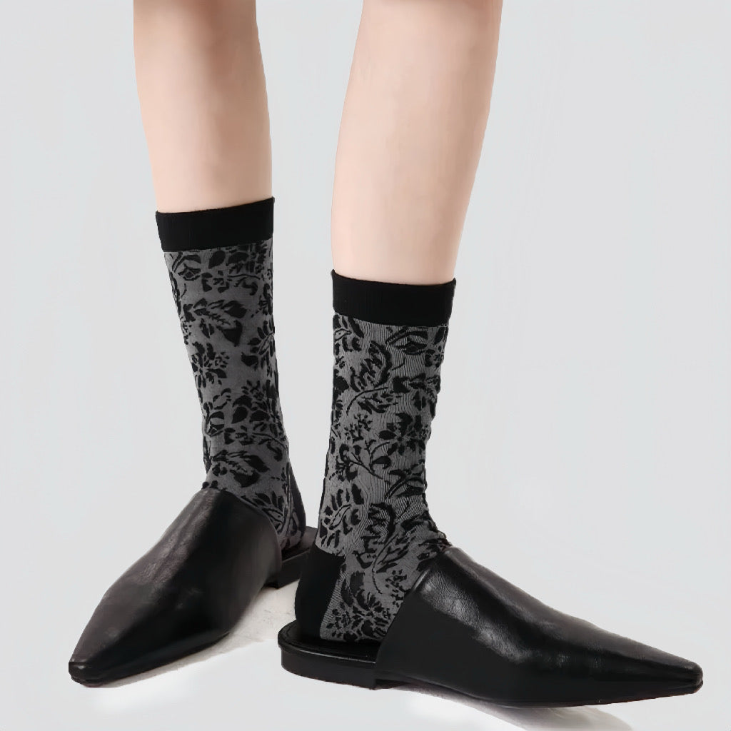 Flat lay of Mystic Floral Socks in black socks, great for daily wear and lounging.