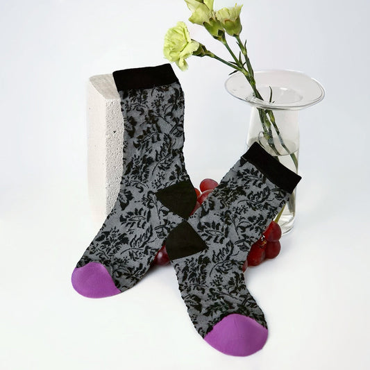 Front view of Mystic Floral Socks: Gray cotton-polyester socks with black floral pattern, black cuffs and purple toes.