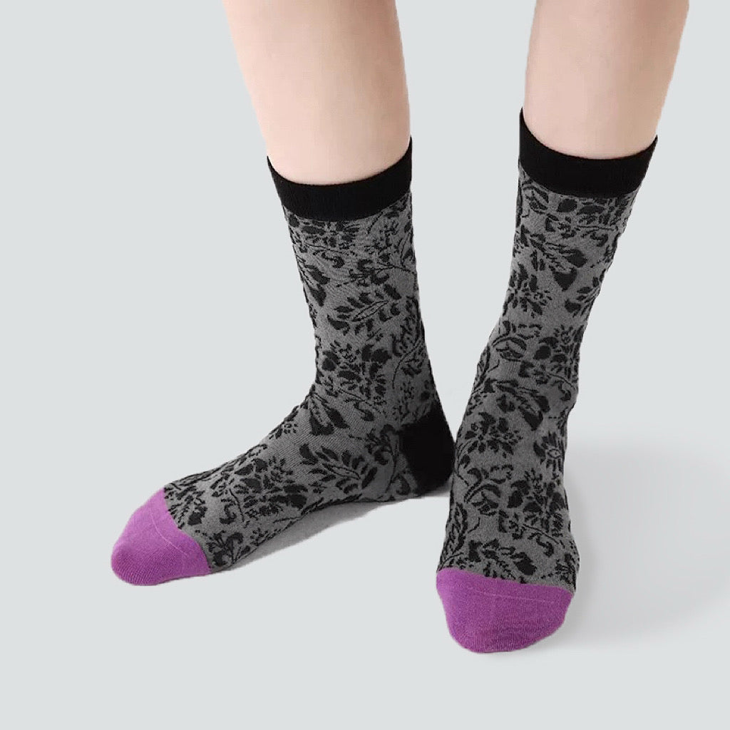 Model wearing a pair of  Mystic Floral Socks, easy to pack for travel and errands.