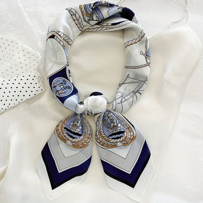 Front view of a tied satin scarf in navy,  elegant accessory styling for handbags.