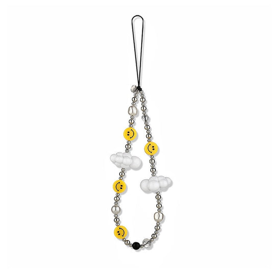 Front view of phone charm with yellow smiley faces, white cloud beads, and clear beads on a black cord.