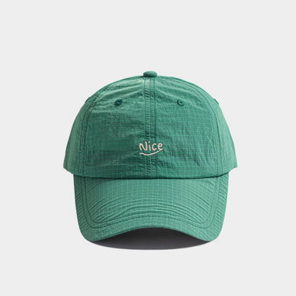 Front flat view of the dark green polyester quick dry cap with minimal text embroidery detail.