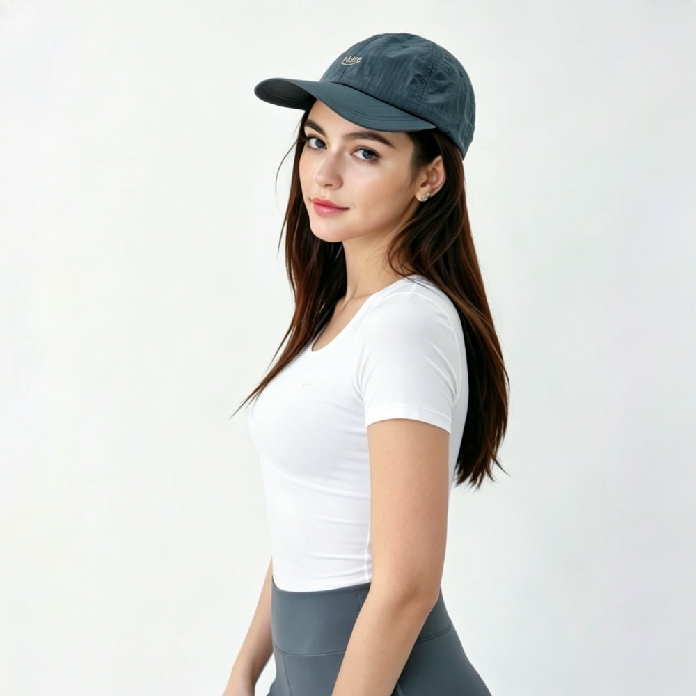 Side profile of the model wearing the steel grey performance cap in a clean gorpcore style.
