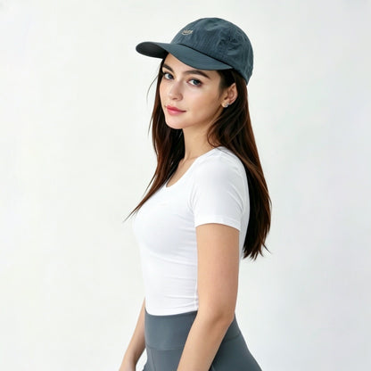 Side profile of the model wearing the steel grey performance cap in a clean gorpcore style.