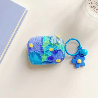 Close-up of blue flower Oil Painting AirPods Case Cover, ideal for gifting.