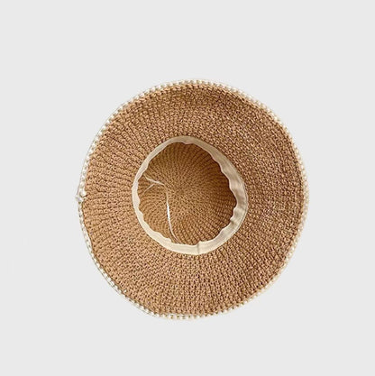 A top-down view of a woven straw hat, showcasing  interior lining and drawstring for size adjustment.