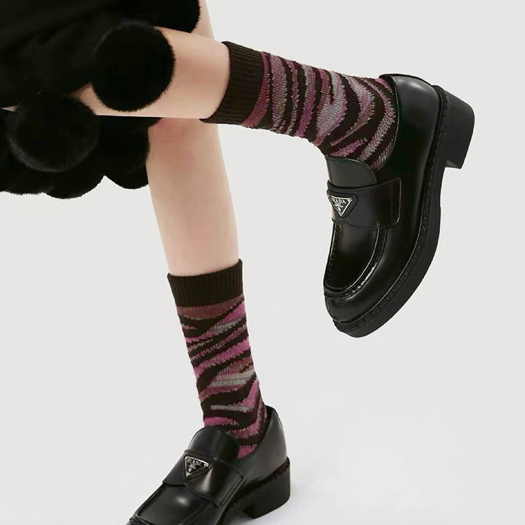 Model wearing a pair of Pink Camouflage Socks, easy to pack for travel and errands.