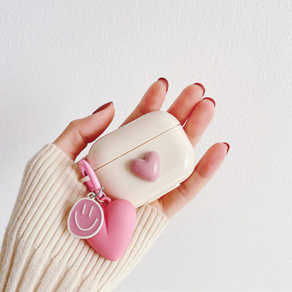Hands holding a pink heart airpods case, easy to carry for commutes and travel; for office.