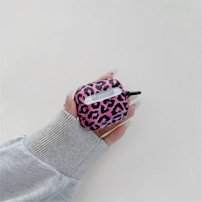 Model Hands holding a pink leopard print airpods case, ideal for gifting and everyday carry.