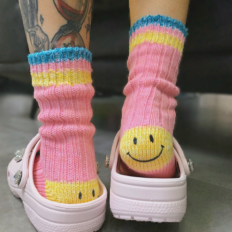 Pink striped socks featuring a hidden smile for a playful, unique look